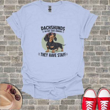 Dachshund wearing sunglasses with text "Dachshunds Do Not Have Owners".
