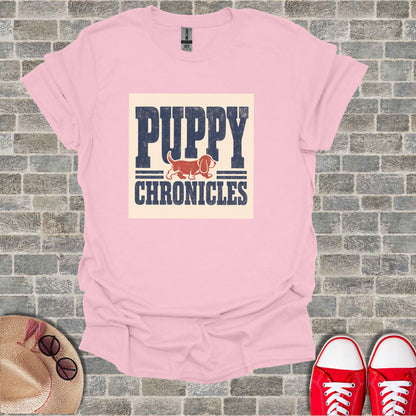 Pink t-shirt with "PUPPY CHRONICLES" text and a dog silhouette.