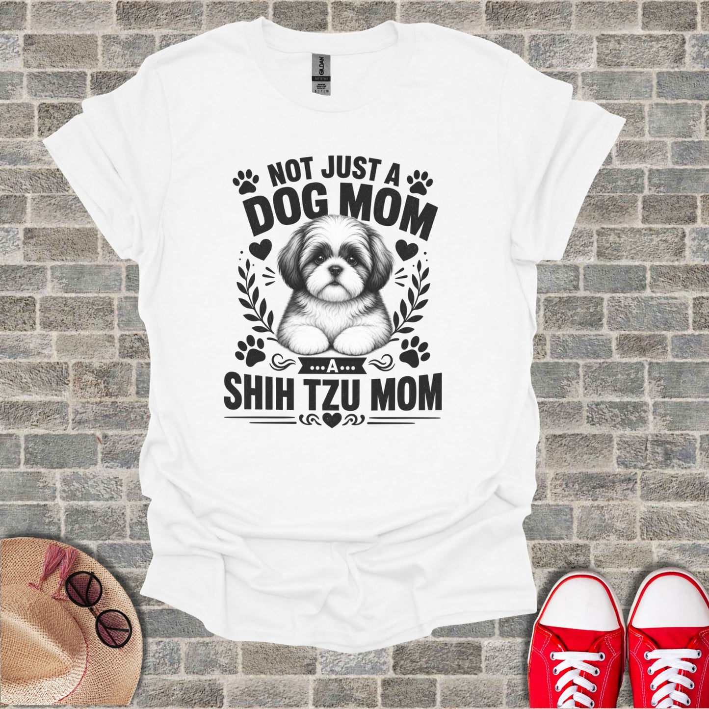 White t-shirt with black graphic of a Shih Tzu and text "Not just a dog mom... a shih tzu mom".