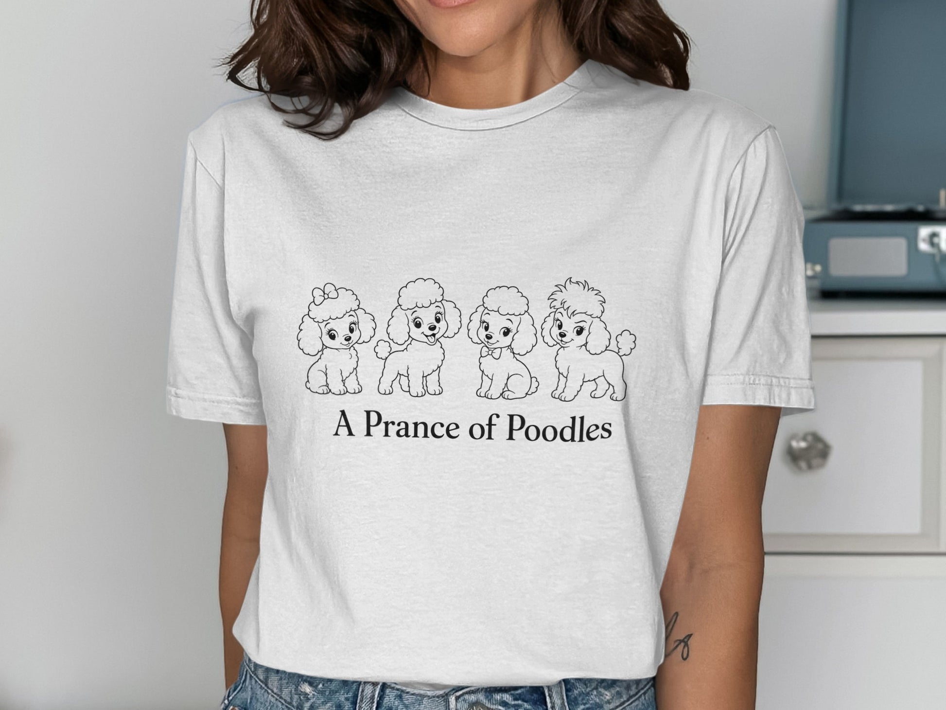 T-shirt with "A Prance of Poodles" text and four cartoon poodles.