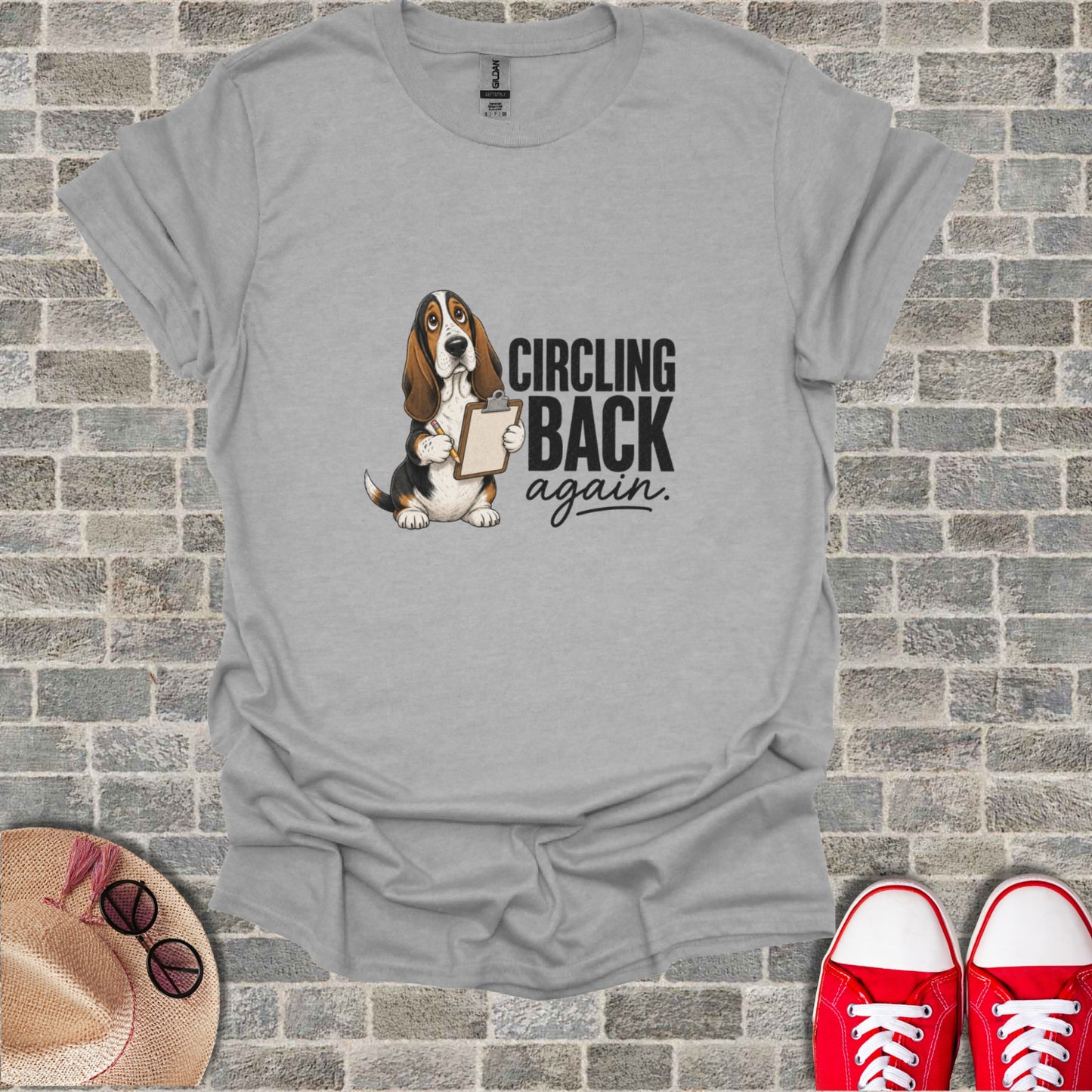 Grey t-shirt with Basset Hound holding clipboard and text "CIRCLING back. again."