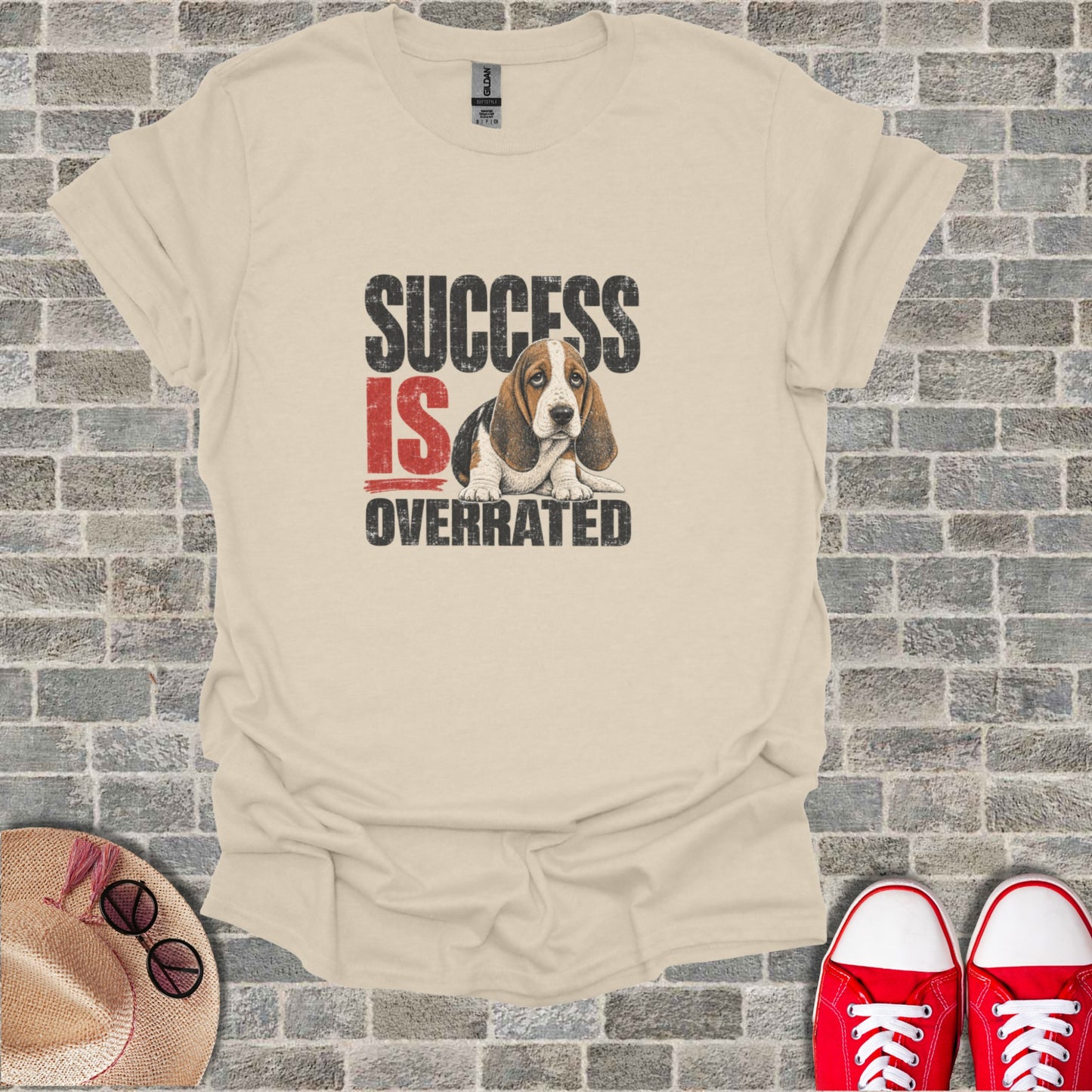 Cream t-shirt with text "SUCCESS IS OVERRATED" and a sad Basset Hound.