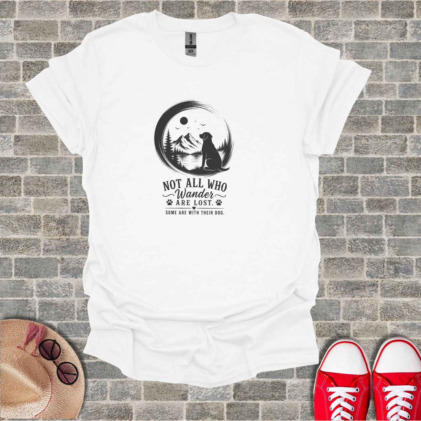 White t-shirt with a circular graphic of a dog, mountains, and text.