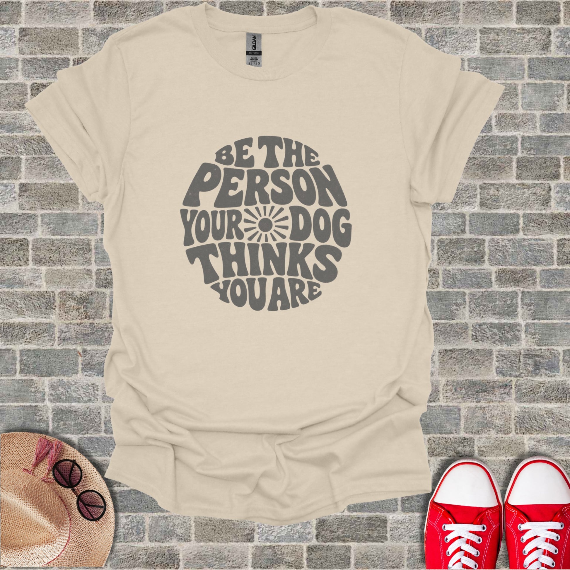 Cream t-shirt with dark gray text saying "Be the person your dog thinks you are".