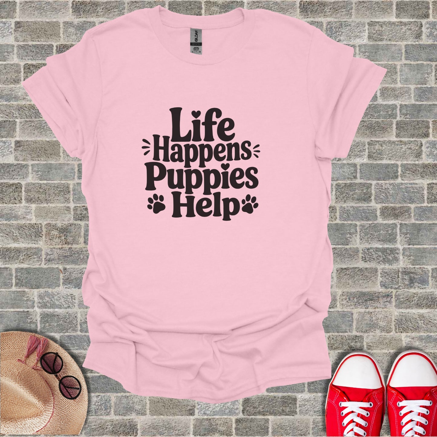 Pink t-shirt with "Life Happens Puppies Help" text and paw prints.