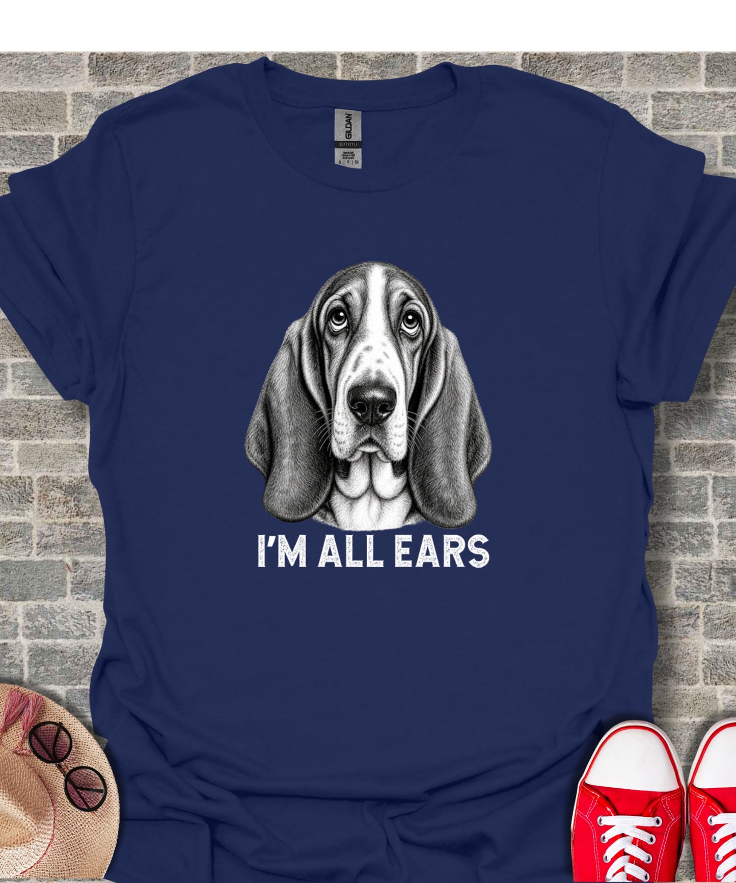 T-shirt with a black and white illustration of a Basset Hound's face, text reads "I'M ALL EARS".