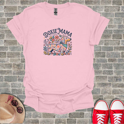 Pink t-shirt with a colorful dachshund illustration and "Doxie Mama" text.