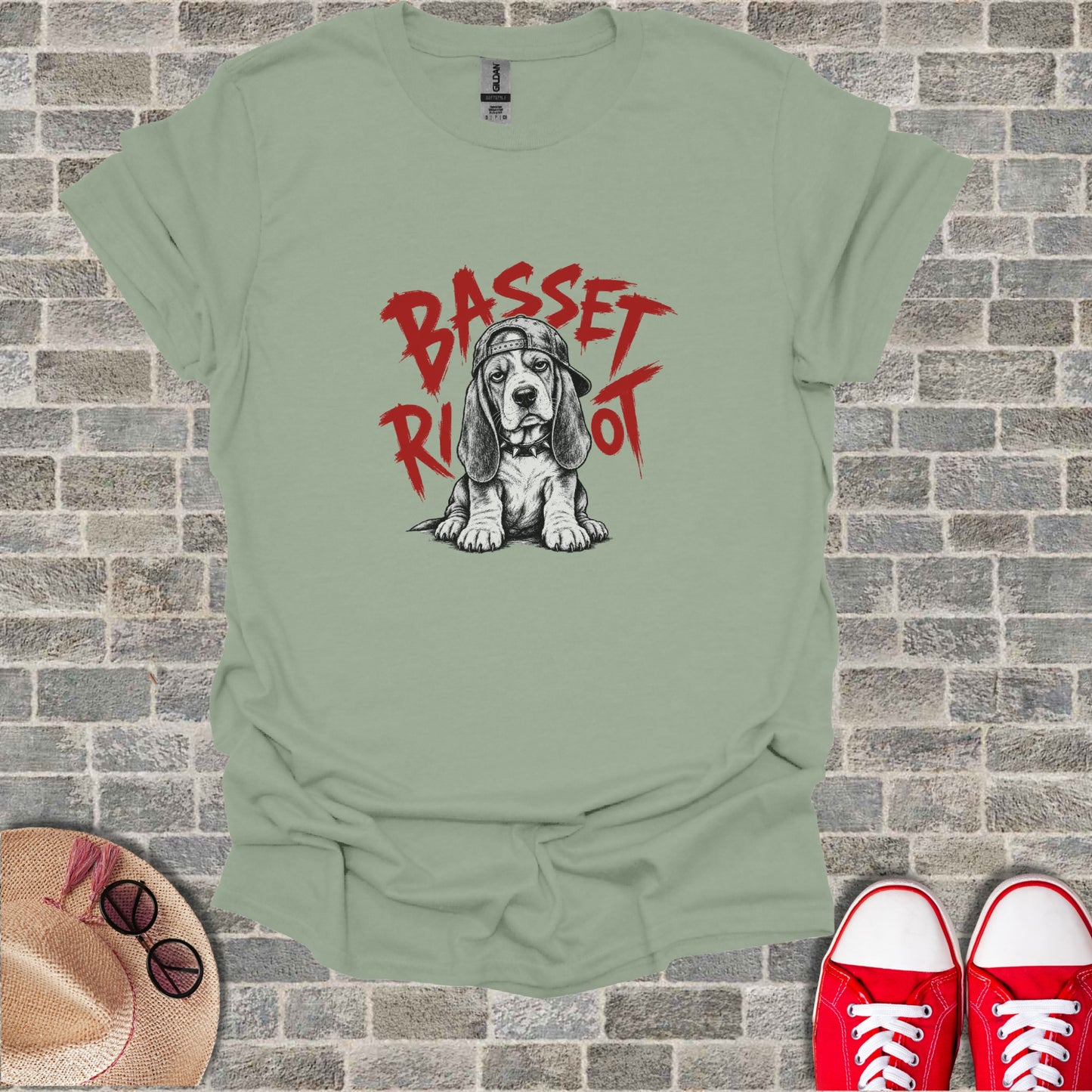 Basset Hound wearing a baseball cap with "Basset Riot" text.