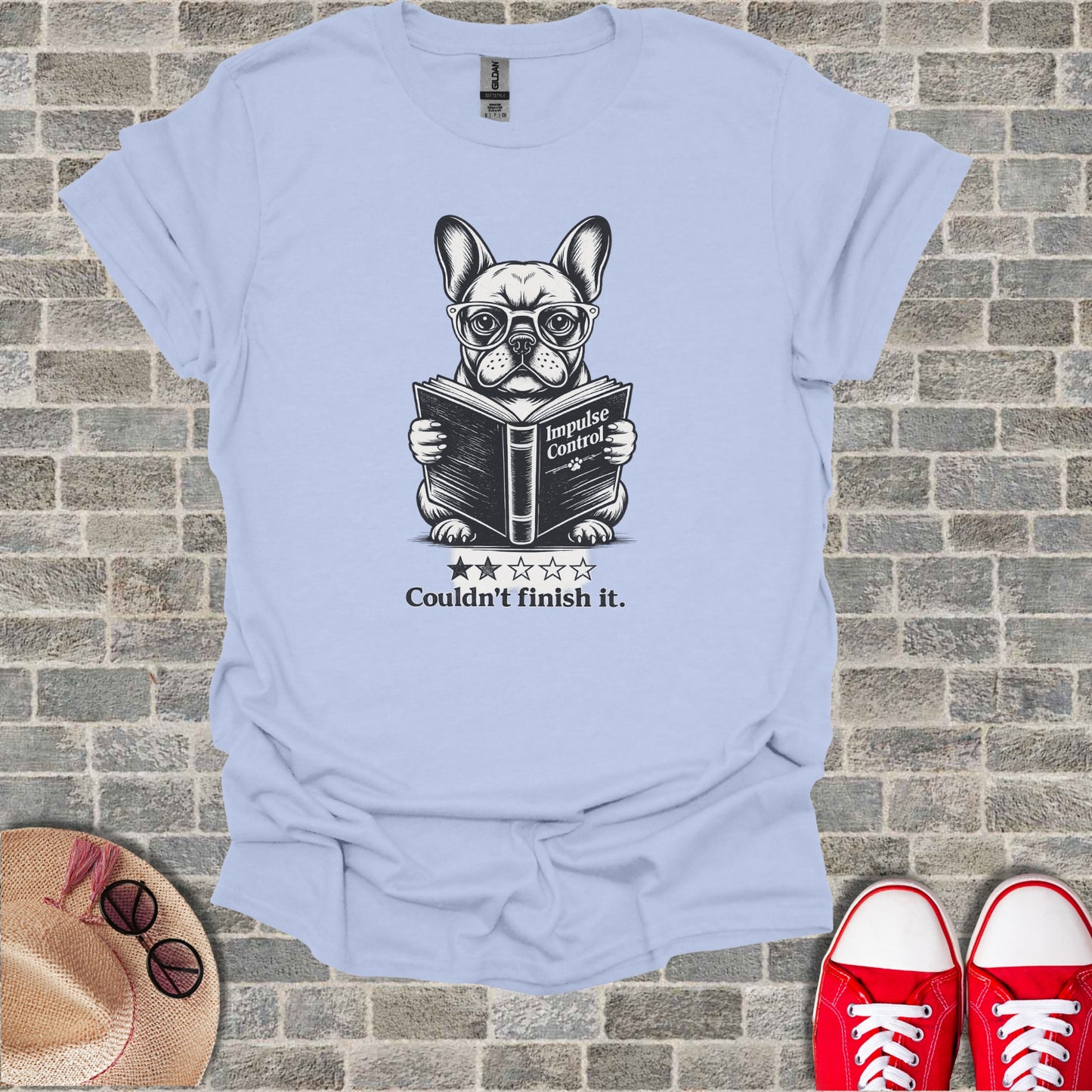 French bulldog wearing glasses reads "Impulse Control" book.