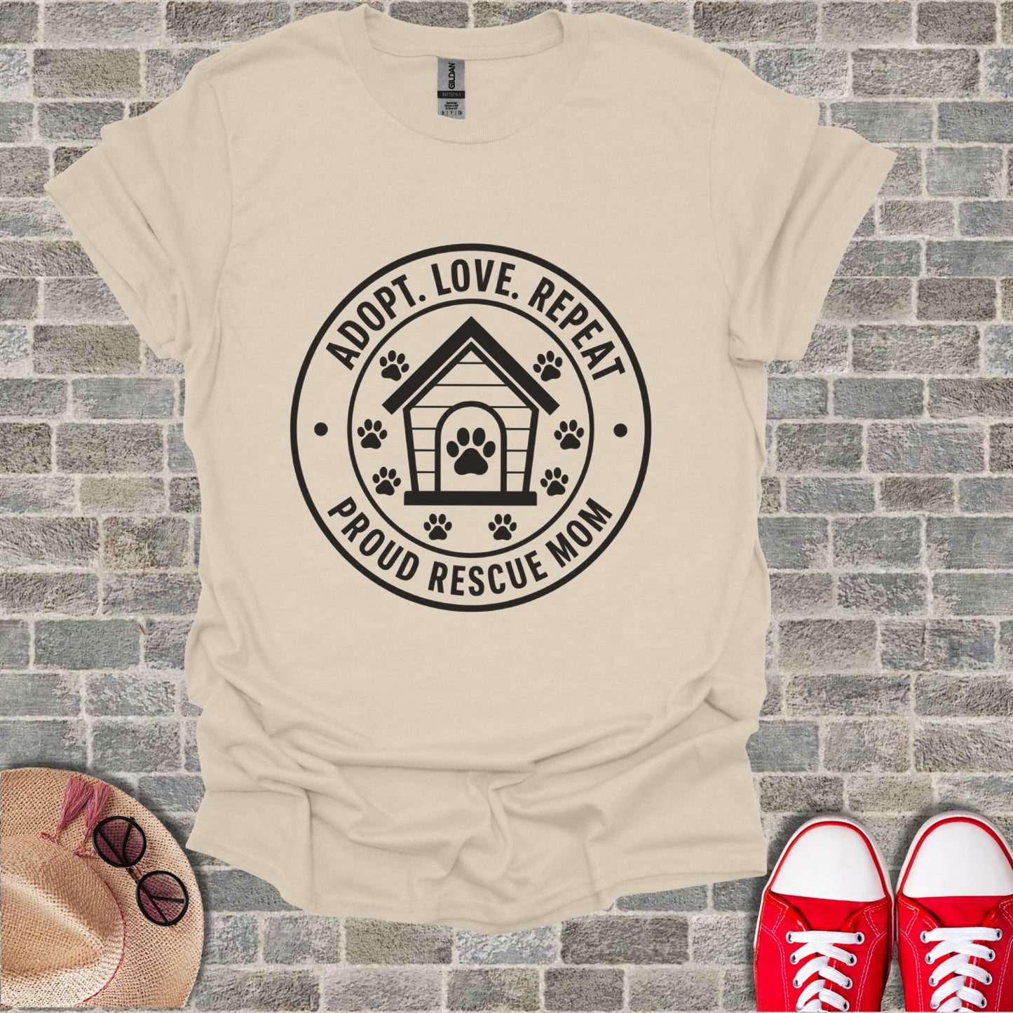Cream t-shirt with black graphic: "Adopt. Love. Repeat. Proud Rescue Mom."