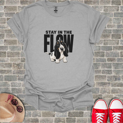 Basset hound wearing a bandana with "STAY IN THE FLOW" text.