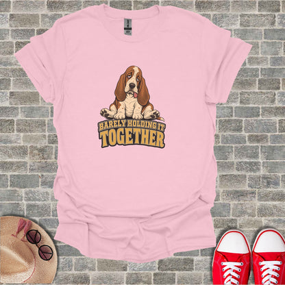 Pink t-shirt with cartoon Basset Hound and text "Barely Holding It Together."