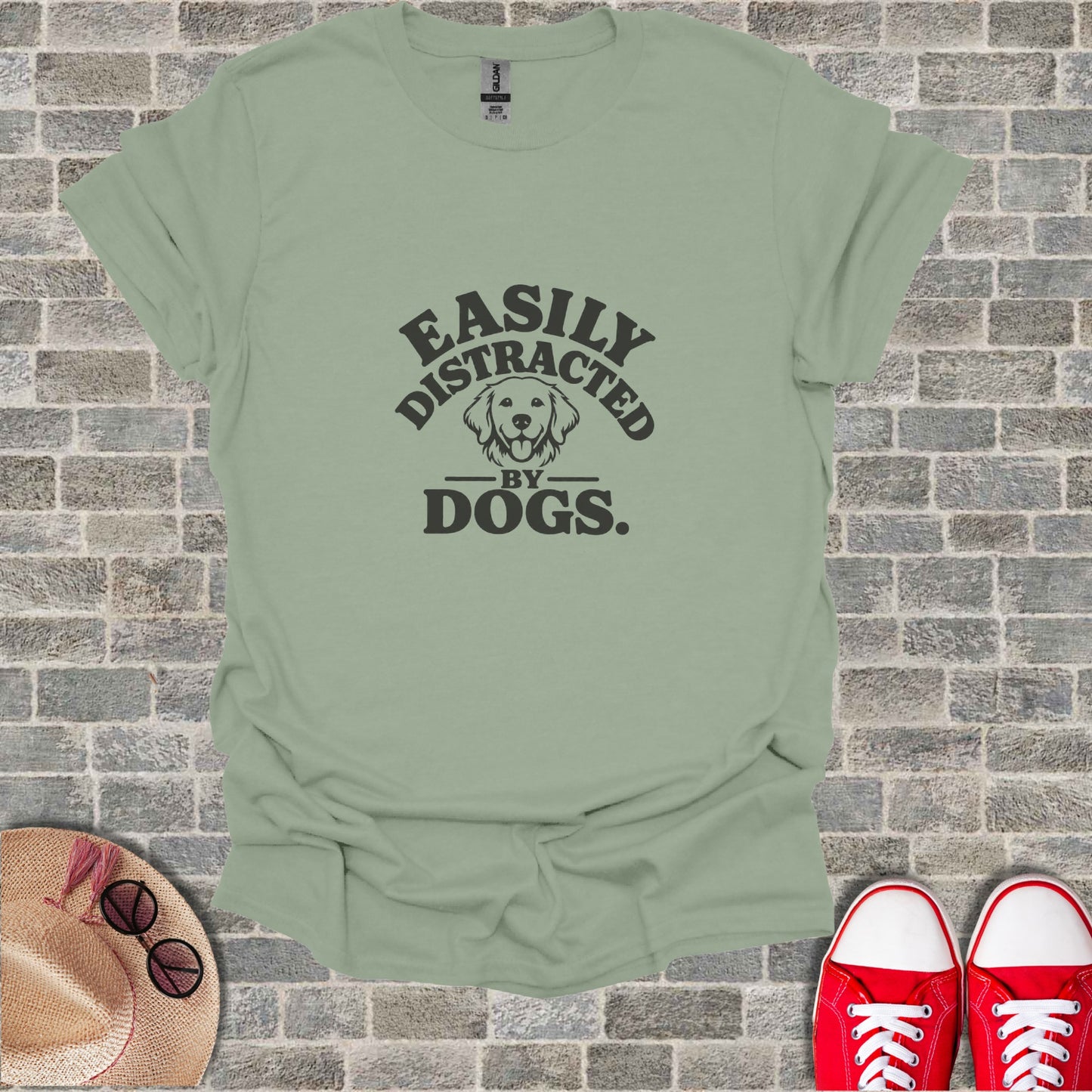 Light green t-shirt with black text reading "Easily Distracted by Dogs."