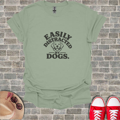 Light green t-shirt with black text reading "Easily Distracted by Dogs."