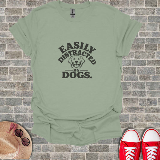Light green t-shirt with black text reading "Easily Distracted by Dogs."