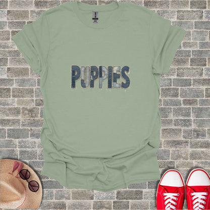T-shirt with "PUPPIES" text in denim font on light green fabric.