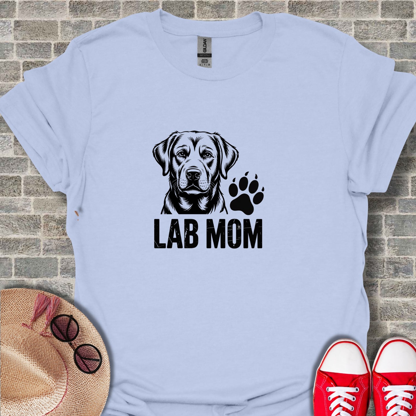 Labrador Mom text with dog portrait and paw print graphic on light blue t-shirt.