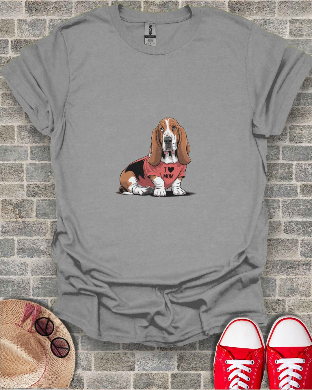 Basset Hound wearing an "I Love Mom" t-shirt on a gray t-shirt.