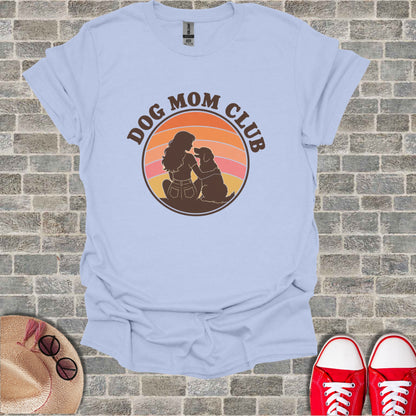Light blue t-shirt with "Dog Mom Club" text and silhouette of woman with dog.