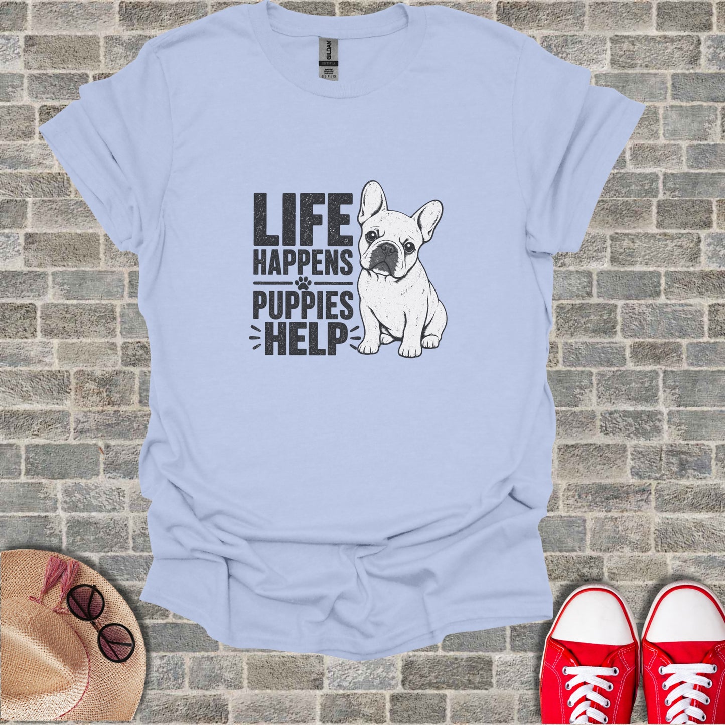 Light blue t-shirt with "LIFE HAPPENS PUPPIES HELP" text and French bulldog graphic.