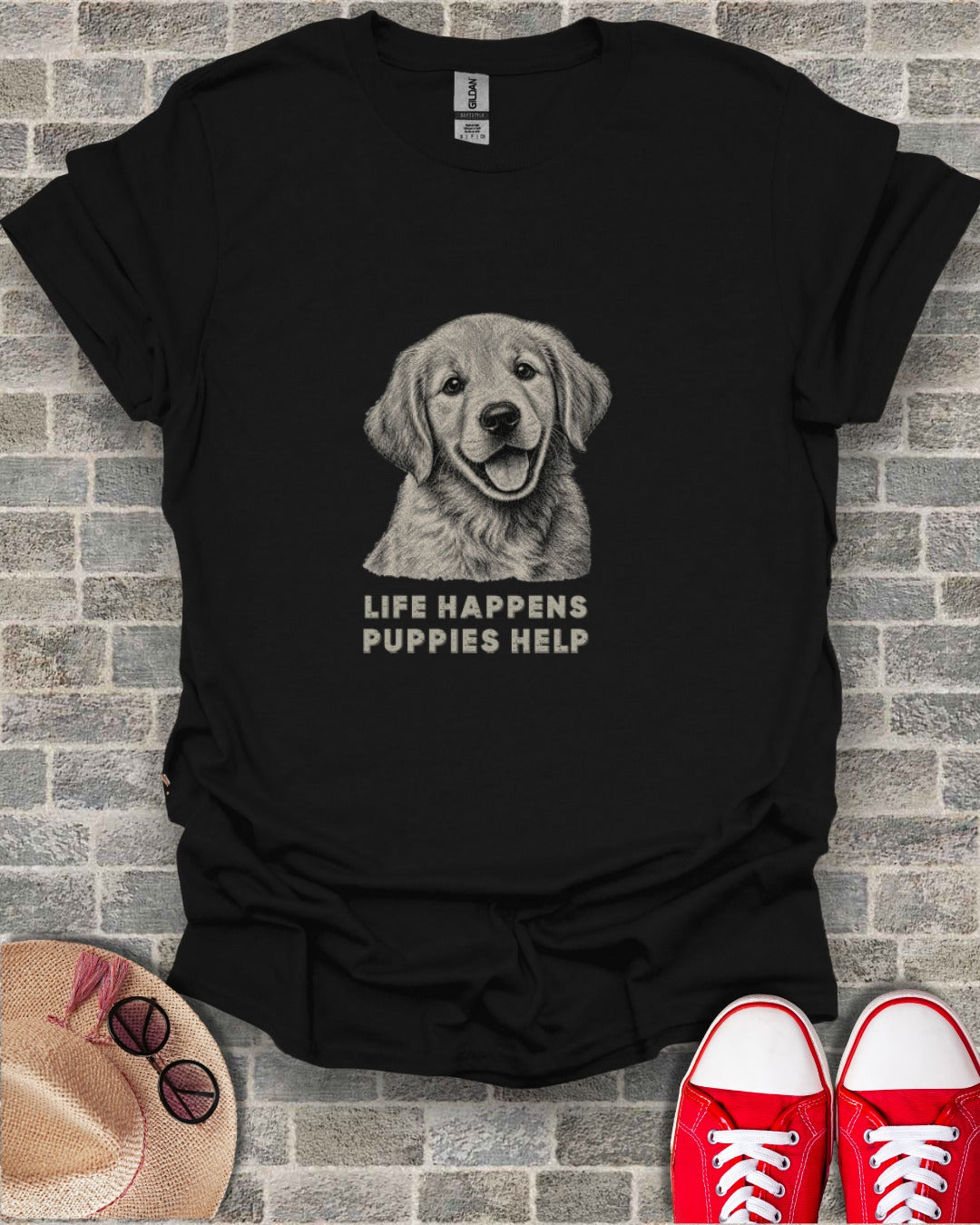 Black t-shirt with a drawing of a Golden Retriever puppy and the text "LIFE HAPPENS PUPPIES HELP".