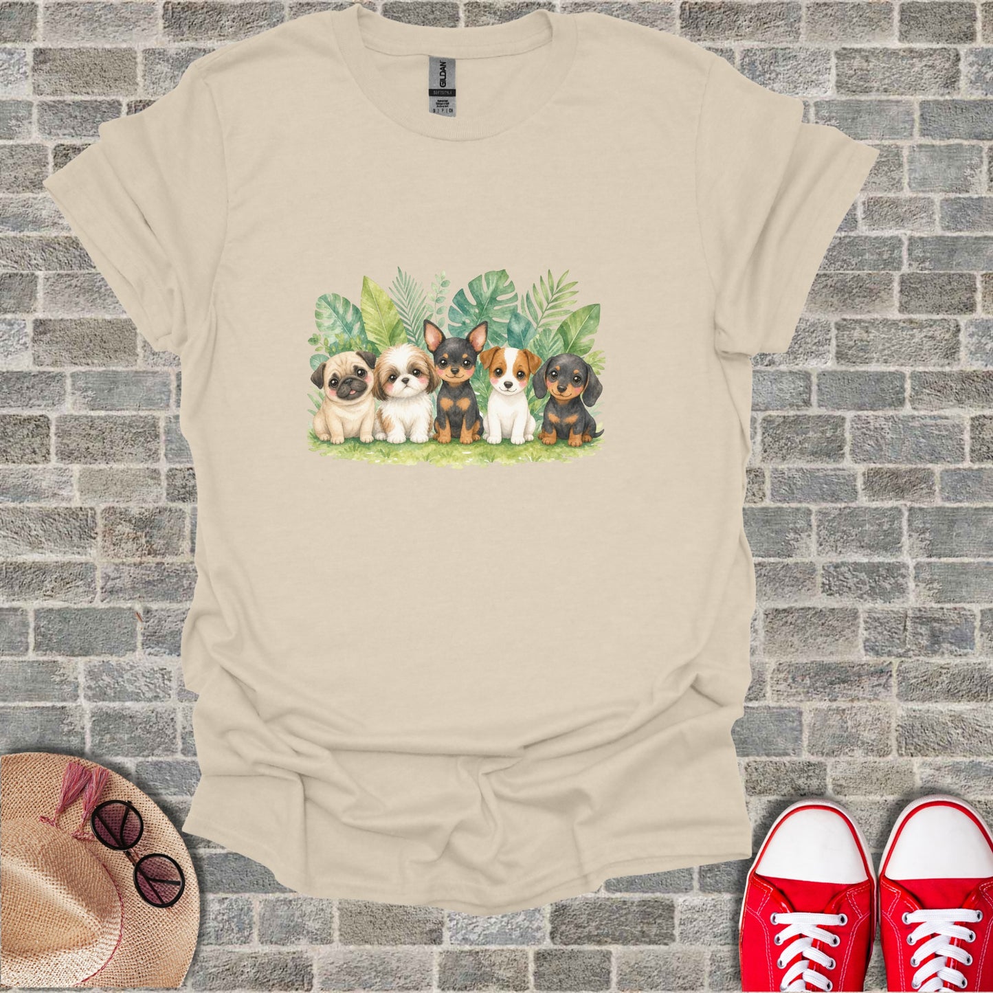 Watercolor illustration of five puppies sitting with green leaves.