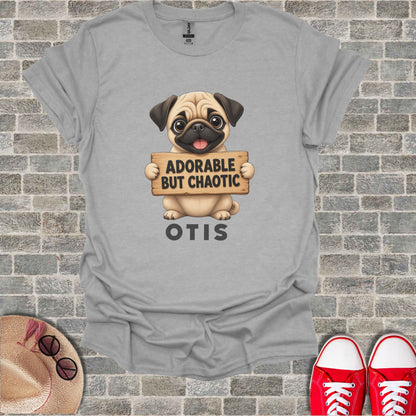 Grey t-shirt with pug holding a sign that says "ADORABLE BUT CHAOTIC OTIS".