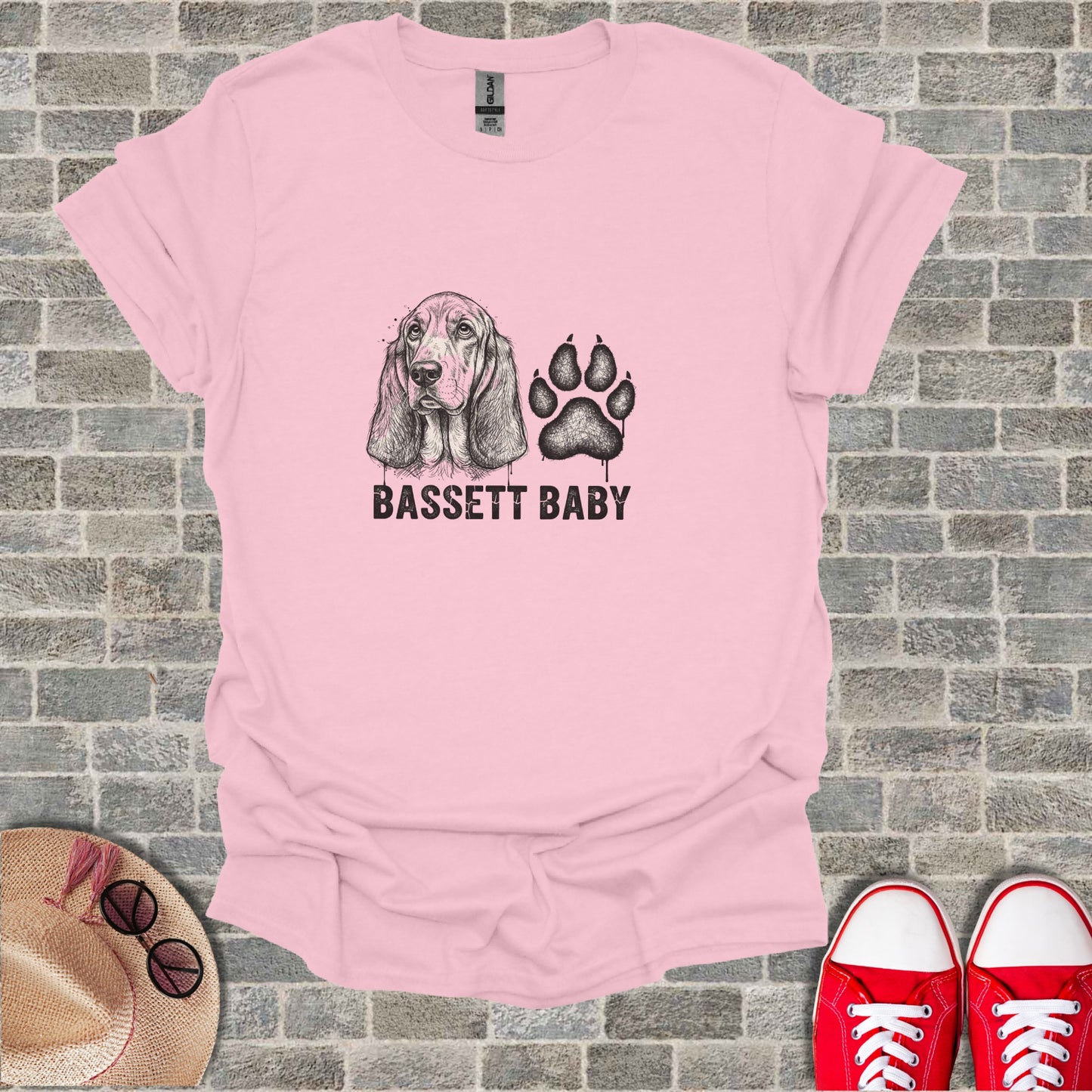 Pink t-shirt with Basset Hound and paw print graphic and "BASSETT BABY" text.