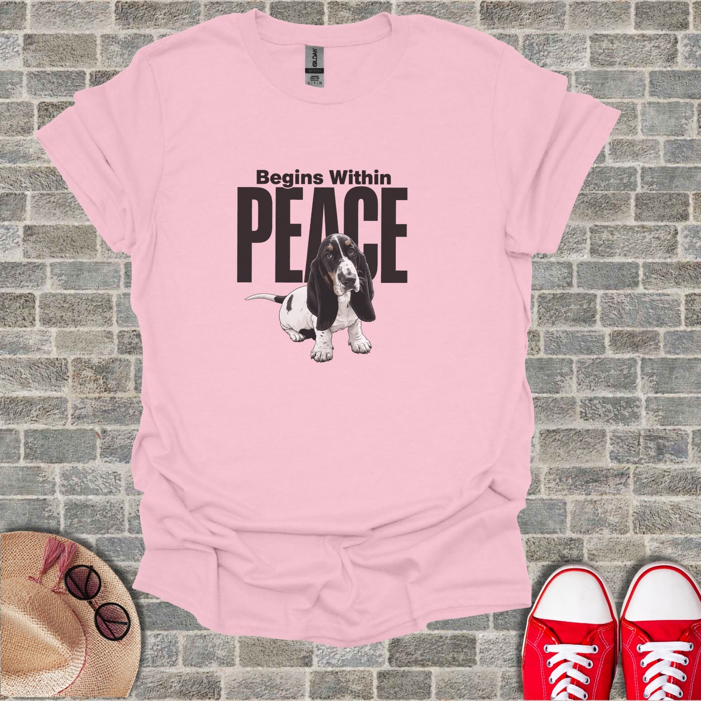 Pink t-shirt with a basset hound graphic and text "Begins Within Peace".