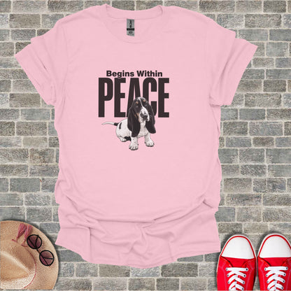 Pink t-shirt with a basset hound graphic and text "Begins Within Peace".