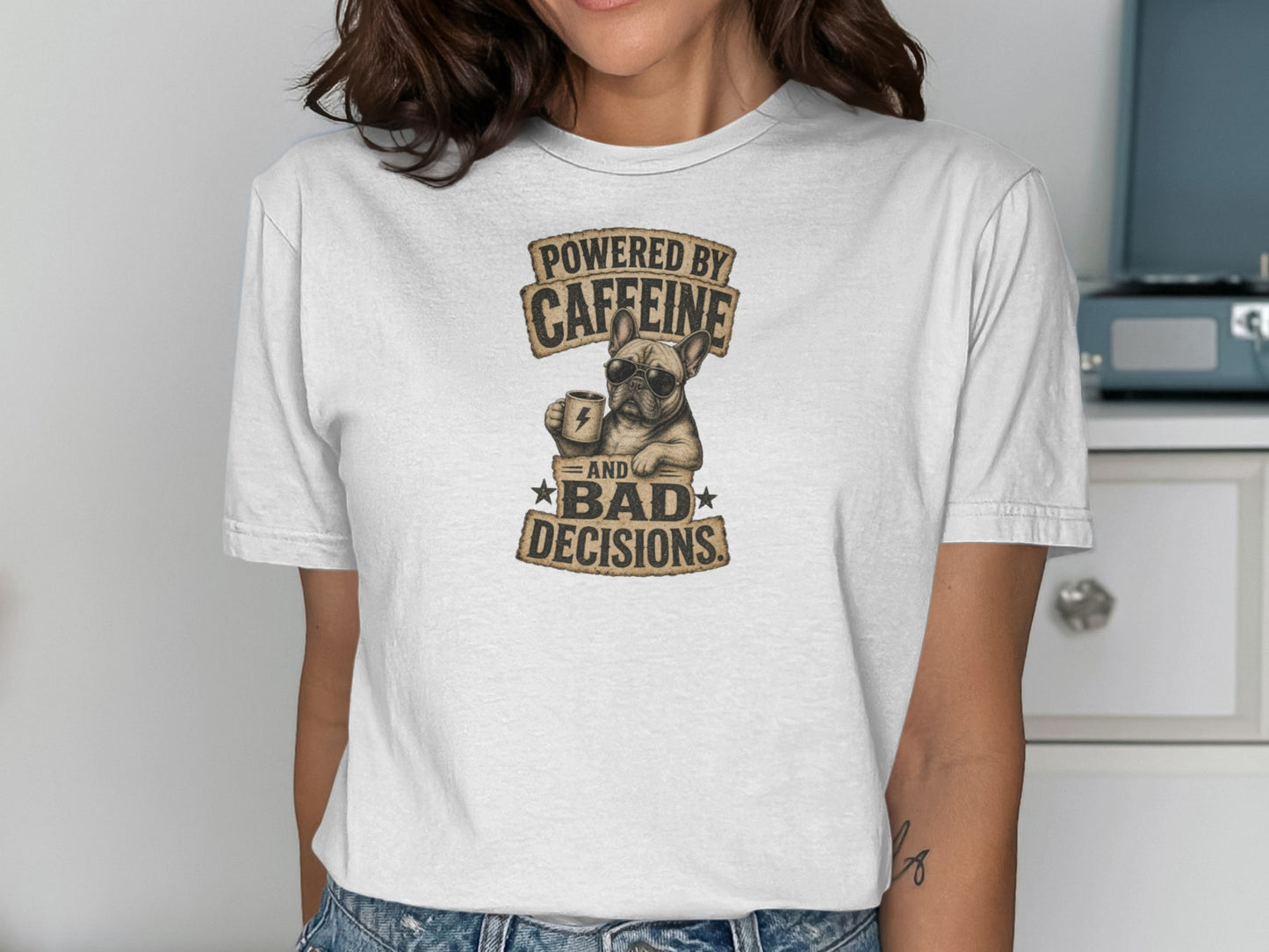 White t-shirt with graphic of dog holding coffee cup, "Powered by Caffeine and Bad Decisions".