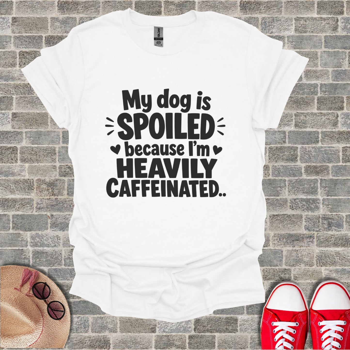 White t-shirt with "My dog is spoiled because I'm heavily caffeinated." text.