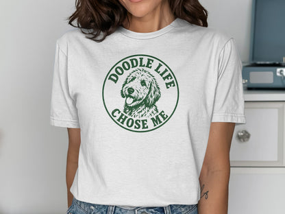 White t-shirt with green circular graphic: "Doodle Life Chose Me" above dog's head.