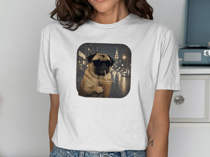 Pug wearing sunglasses holds iced coffee in front of a city night scene.