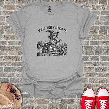 Dog in witch hat riding scooter with text "OFF TO CAUSE A KERFUFFLE".