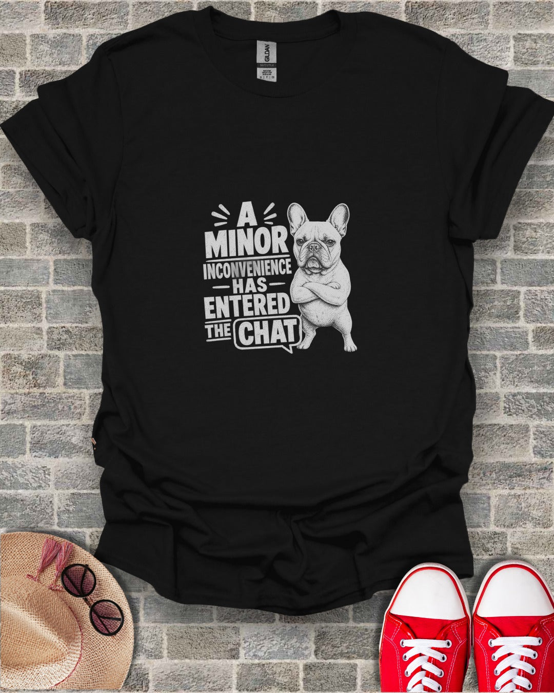 Black t-shirt with a French bulldog and text "A minor inconvenience has entered the chat."