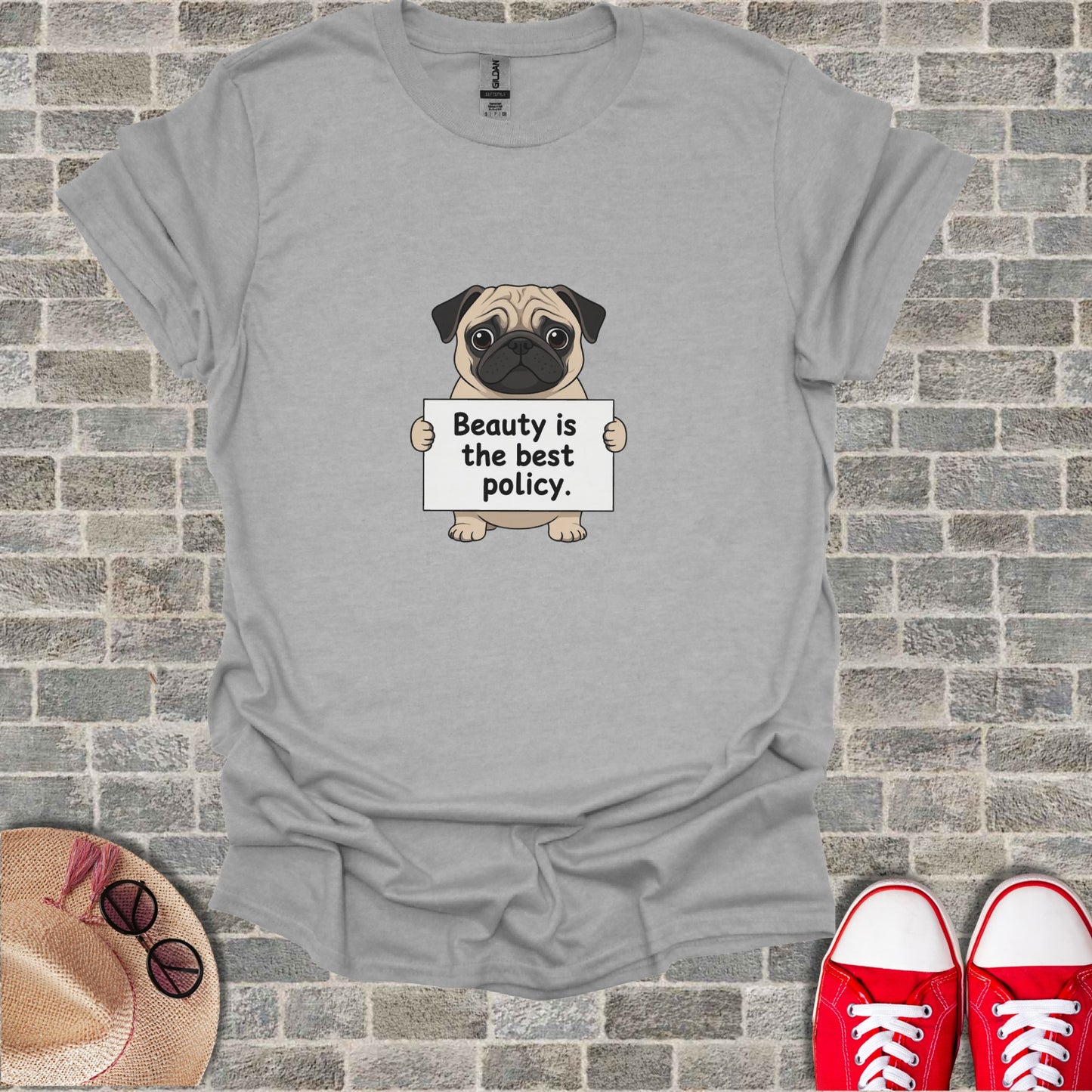 Grey t-shirt with a pug holding a sign that says "Beauty is the best policy."