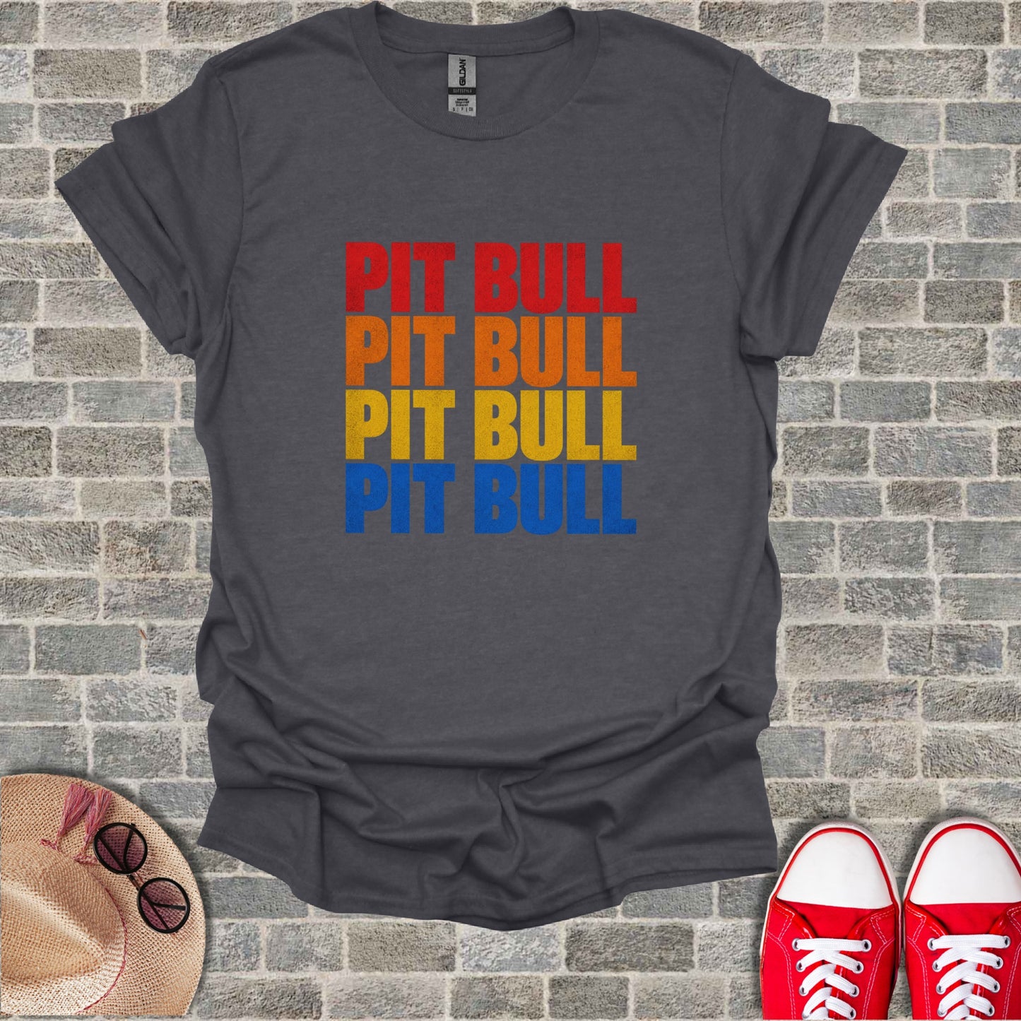 Dark grey t-shirt with "PIT BULL" in stacked orange, red, and yellow text.