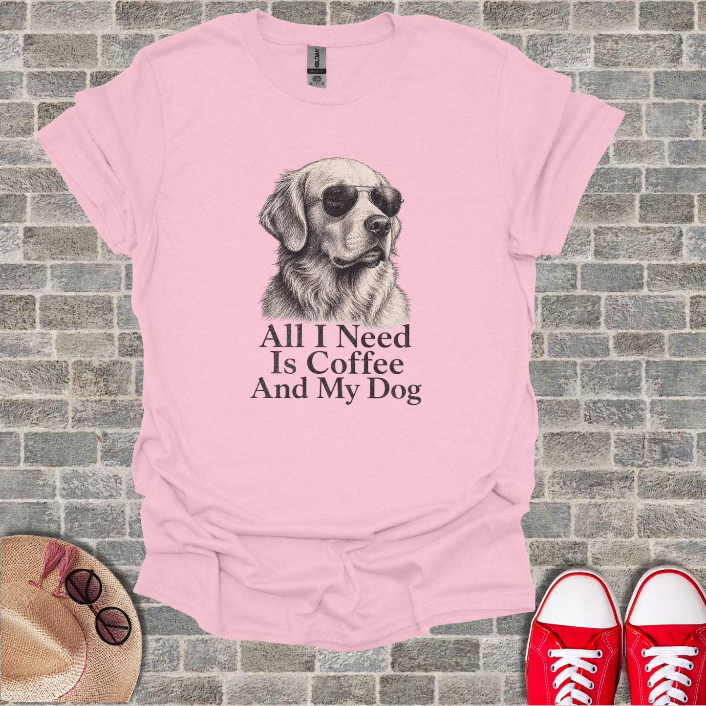 Pink t-shirt with sketch of golden retriever wearing sunglasses. Text reads "All I Need Is Coffee And My Dog".