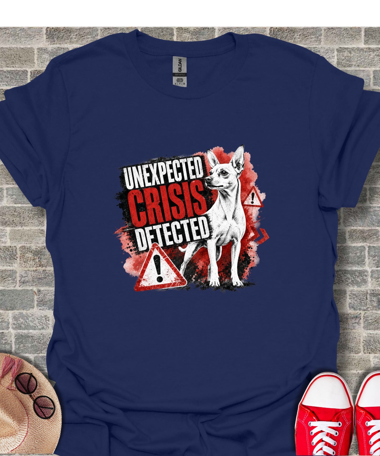 Chihuahua with "Unexpected Crisis Detected" text and warning signs on a dark blue t-shirt.