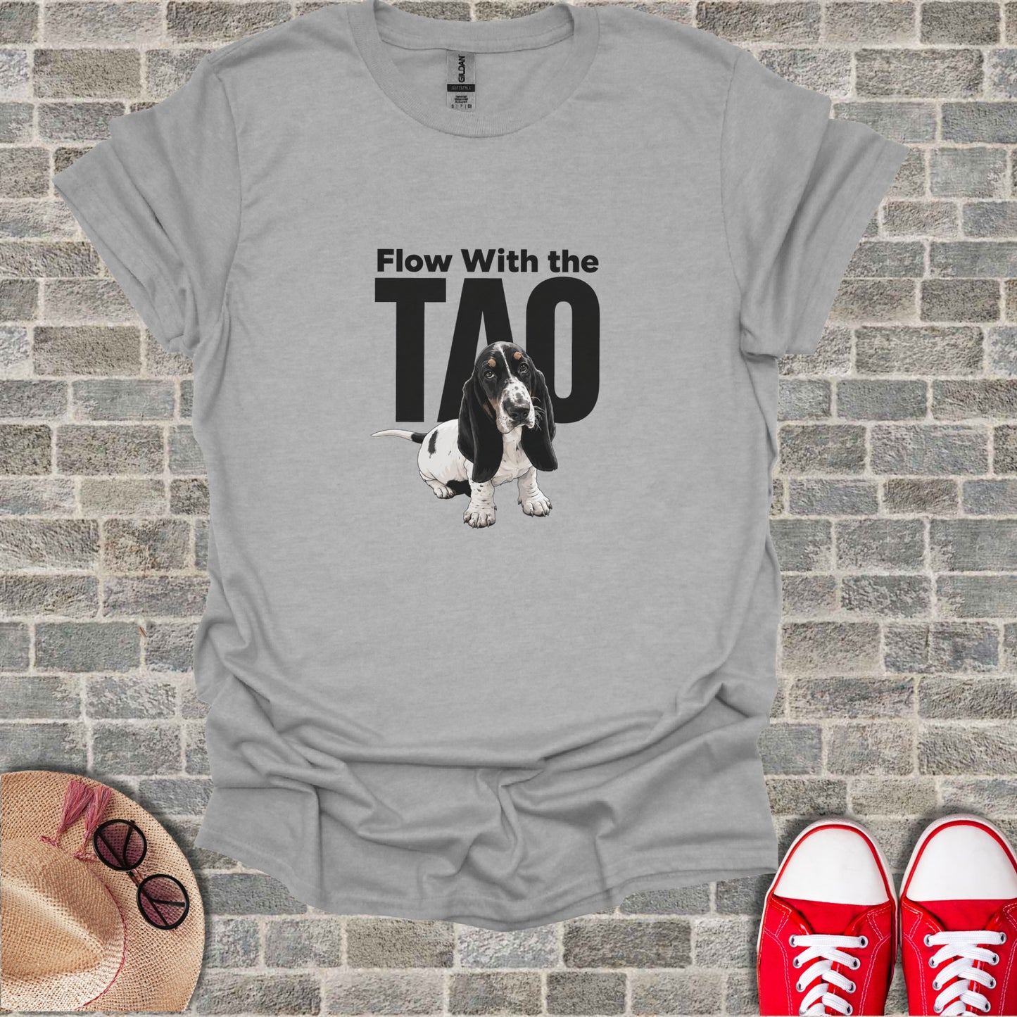Basset hound wearing headphones, with text "Flow With The TAO" on a gray t-shirt.