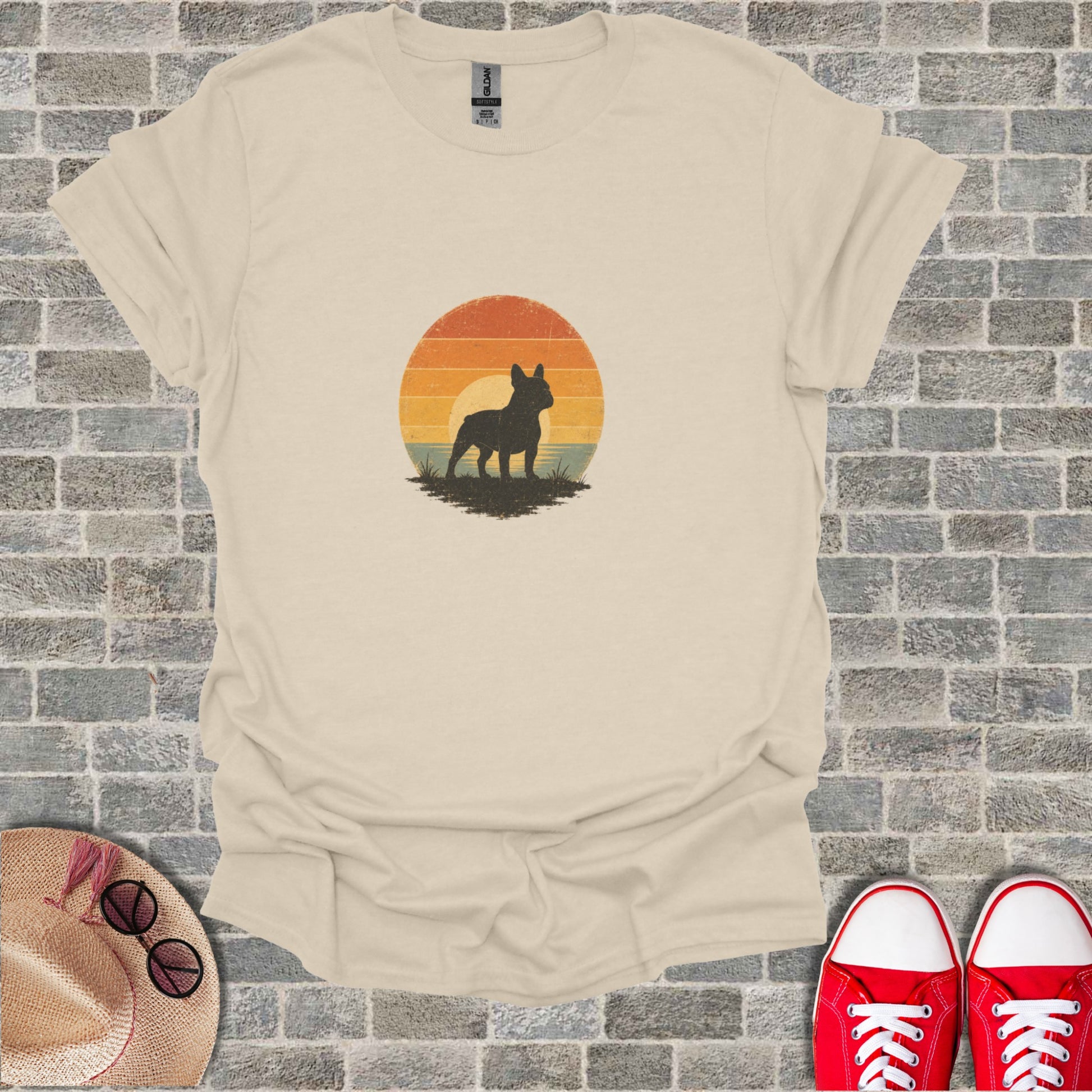 Beige t-shirt with distressed French bulldog silhouette against sunset graphic.