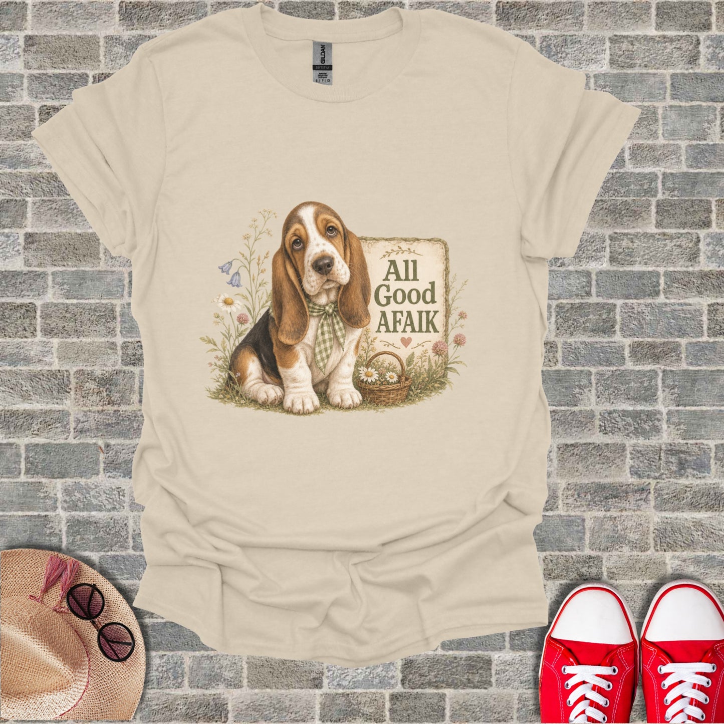 Basset Hound wearing a checkered scarf sits by a basket of flowers with text "All Good Afaik".