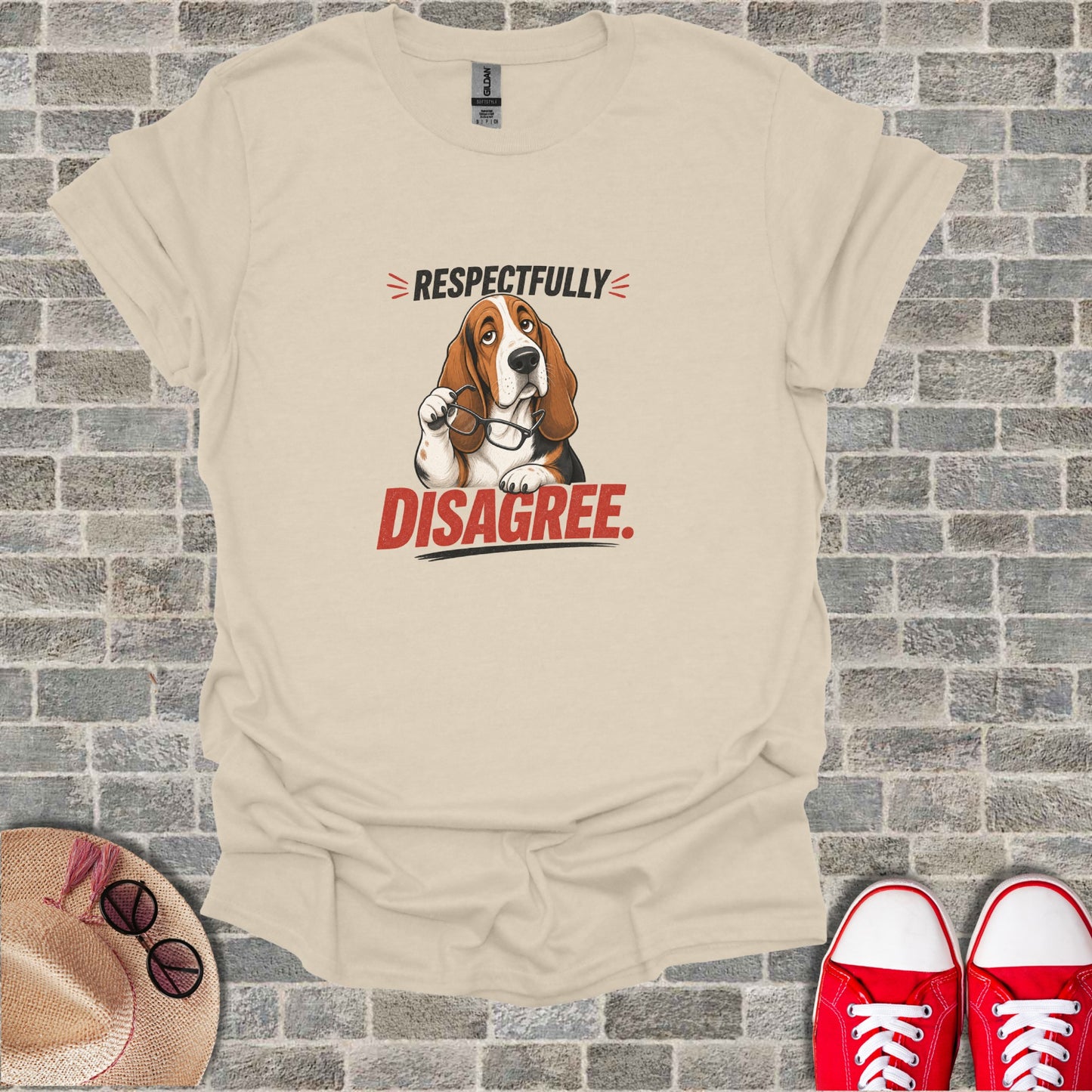 Beige t-shirt with cartoon basset hound holding glasses and text "Respectfully Disagree".