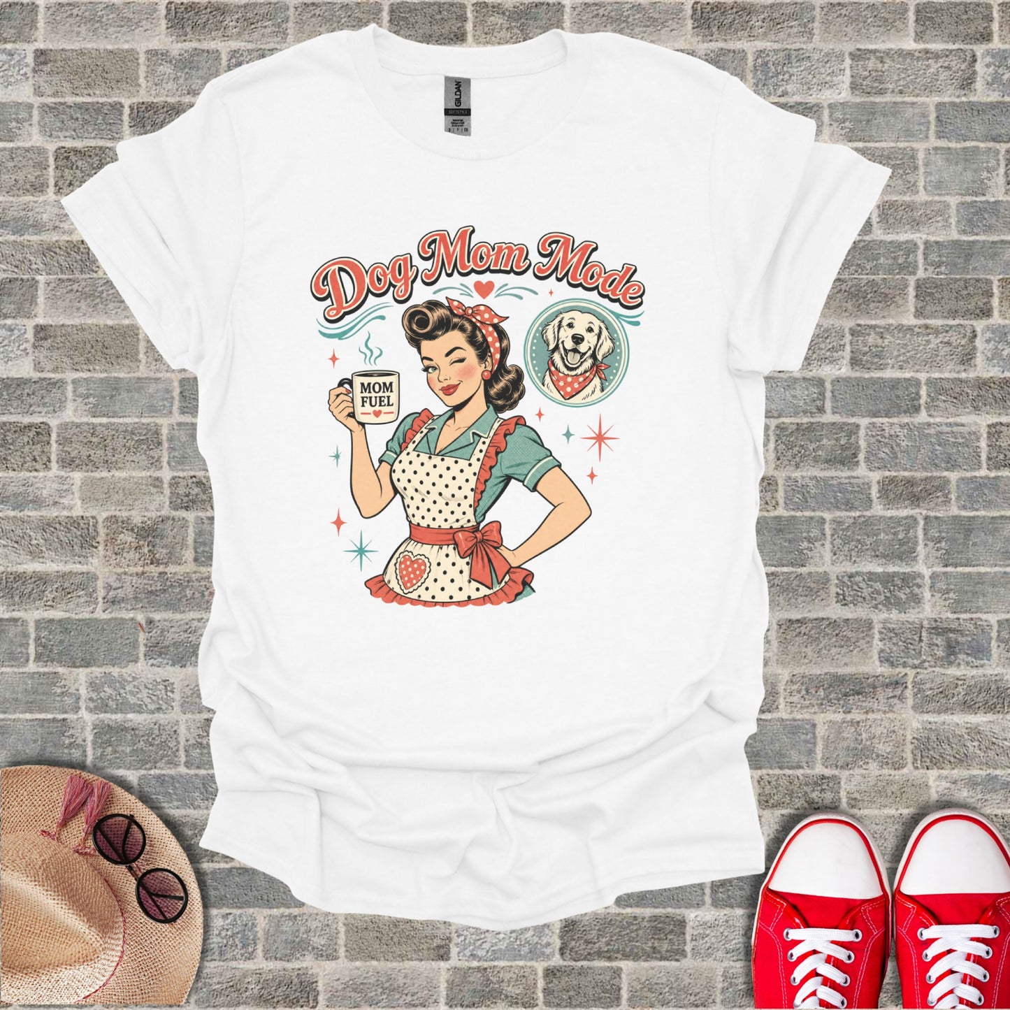 White t-shirt graphic of smiling woman holding "Mom Fuel" mug, with a dog.