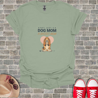 Light green t-shirt with "Not Just a Dog Mom, A Basset Mom" and Basset Hound art.