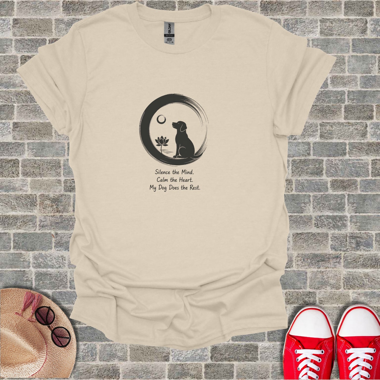 Cream t-shirt with black graphic of dog in circle and inspirational text.