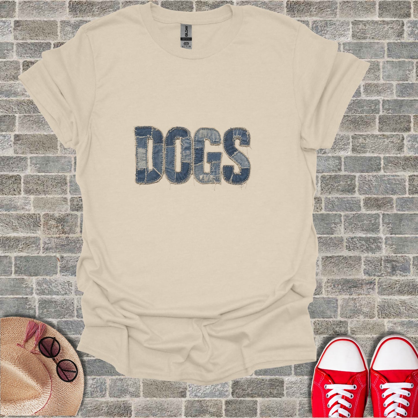 Beige t-shirt with "DOGS" in distressed denim texture, with hat and shoes.