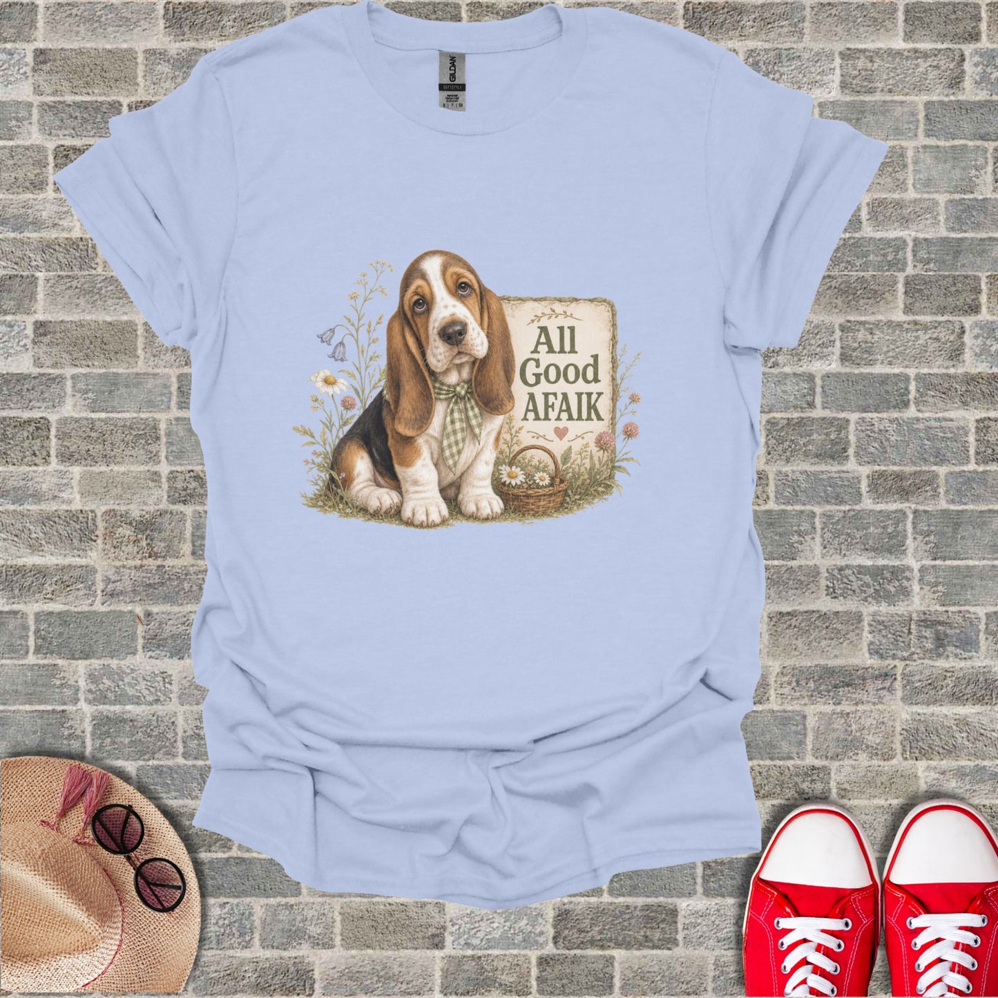 Basset Hound puppy in grass beside a sign that reads "All Good Afaik."