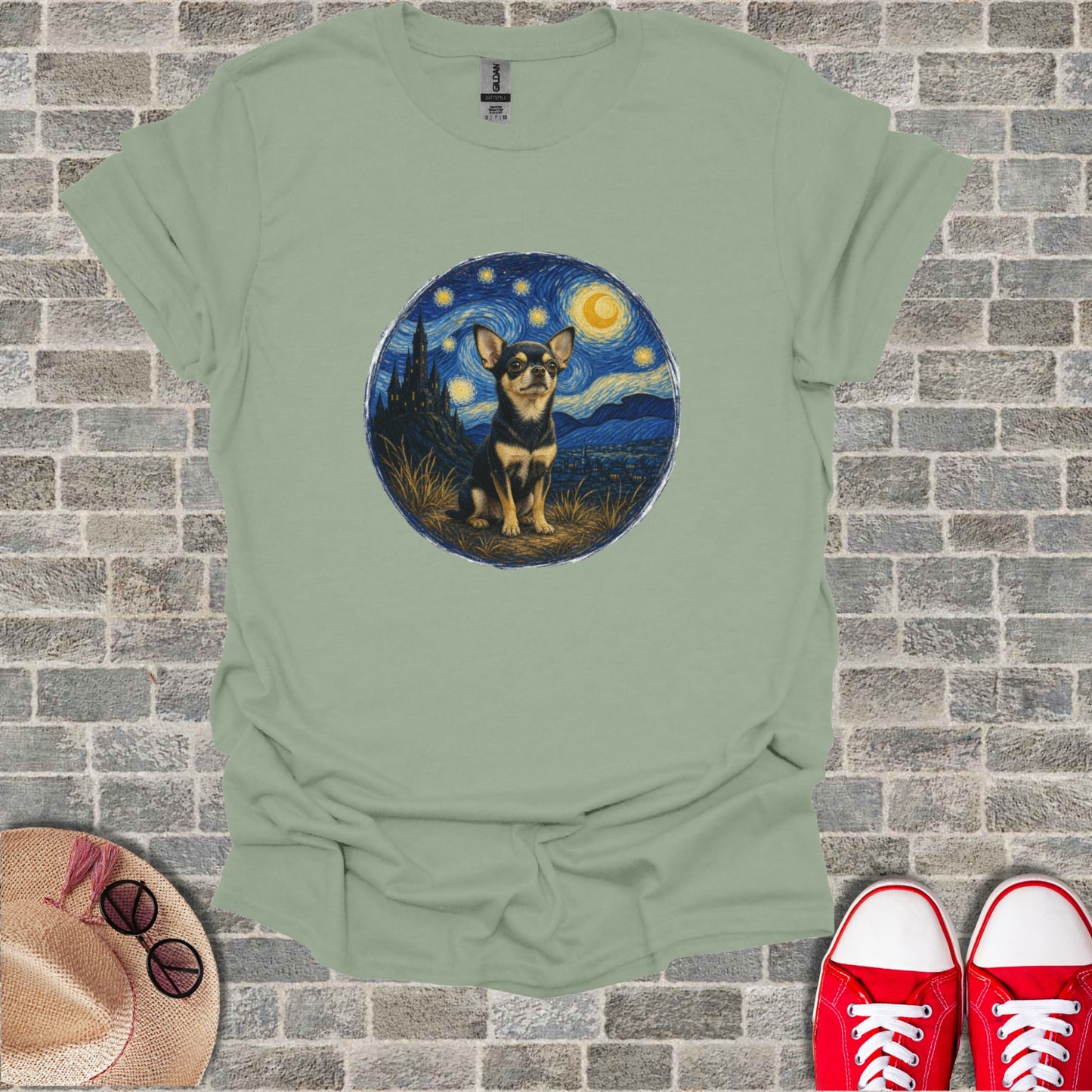 Chihuahua in starry night landscape art on a pale green t-shirt.